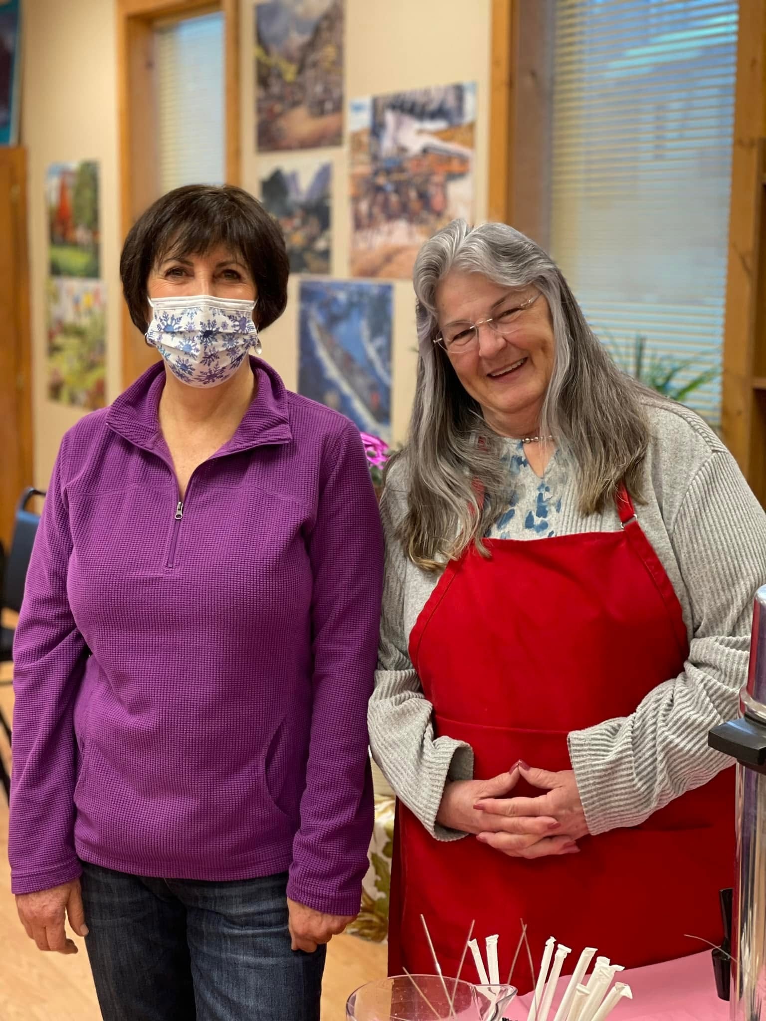 Volunteer and senior community member sharing a warm moment at the McCall Center